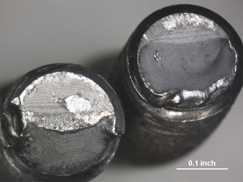 A Moog inspection show the fractured surfaces of a bolt due to stress failure