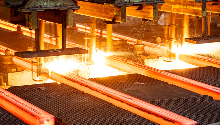hot steel on conveyor Close shot in steel mill