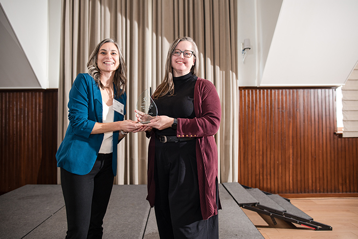 moog employee pulling weeds from ground