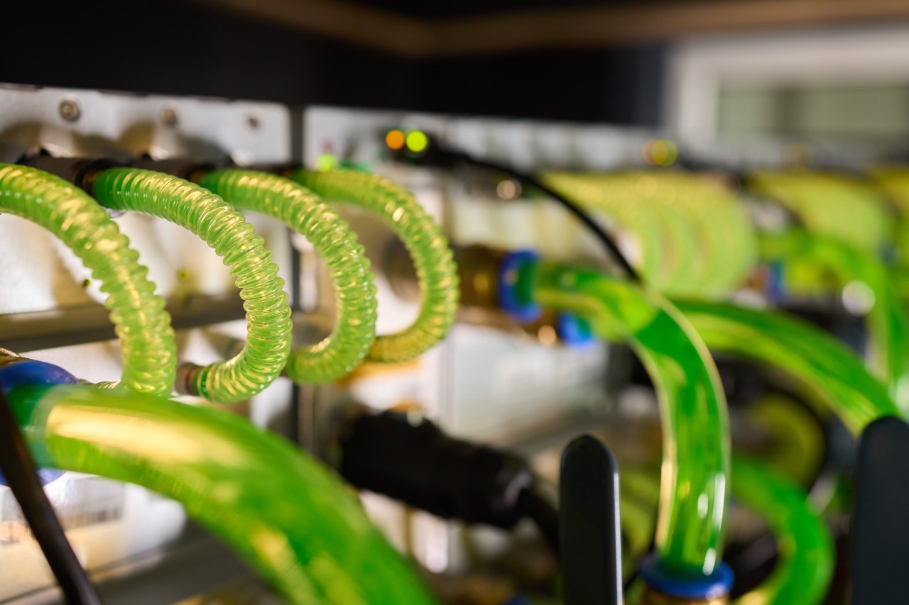 Close-up view of modern server hardware with liquid cooling pipes ensuring optimal temperature control. bitcoin mining farm
